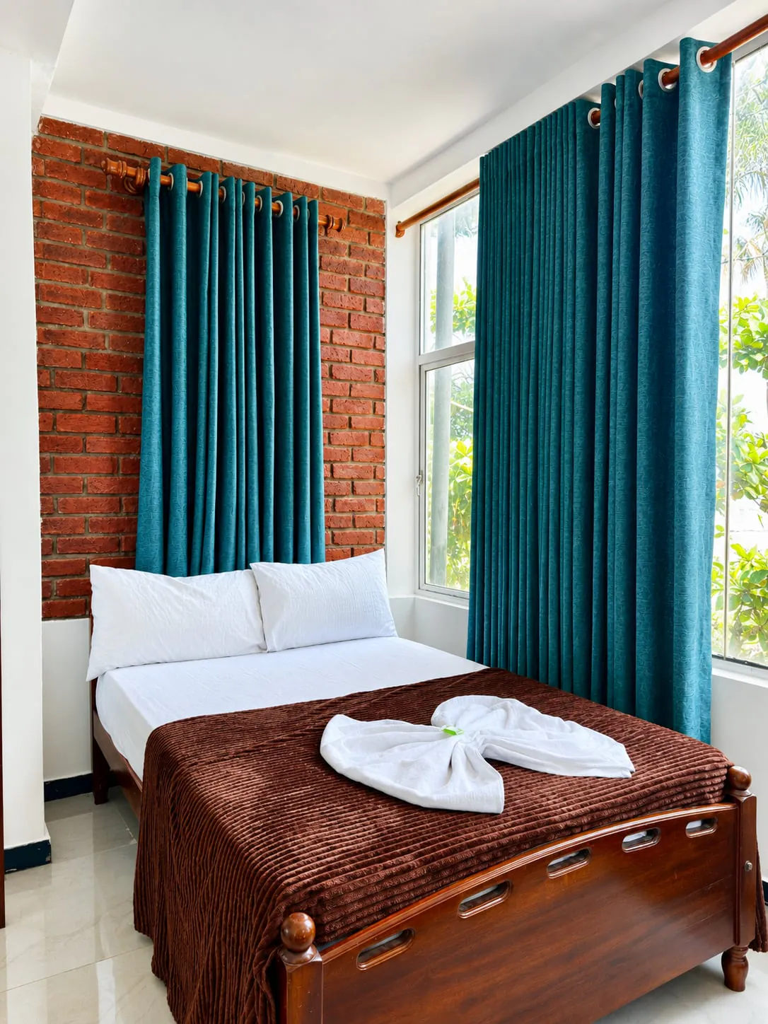 Beach view room with brick wall and carved wooden bed