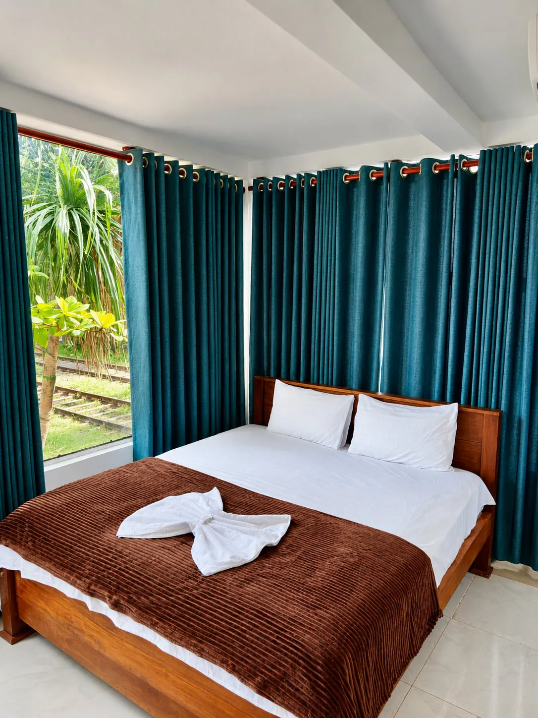 Corner room with wraparound windows and palm views